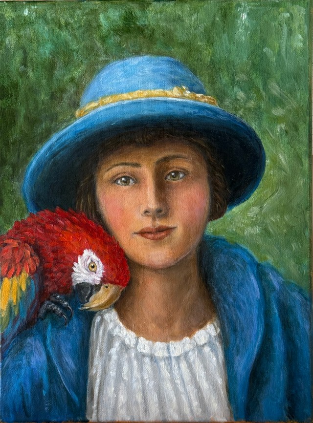 A woman in a blue hat and coat with a macaw on her shoulder.